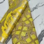golden yellow lace and sego gele vendor in lagos nigeria
